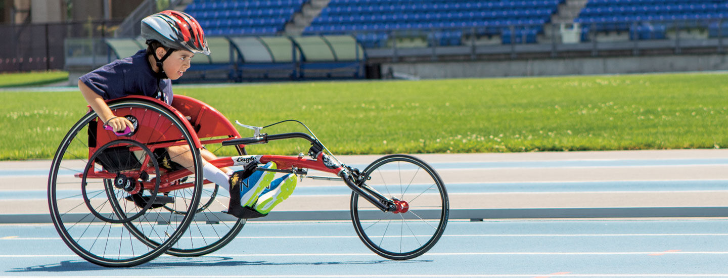 A kid races his specialized bike on a track.