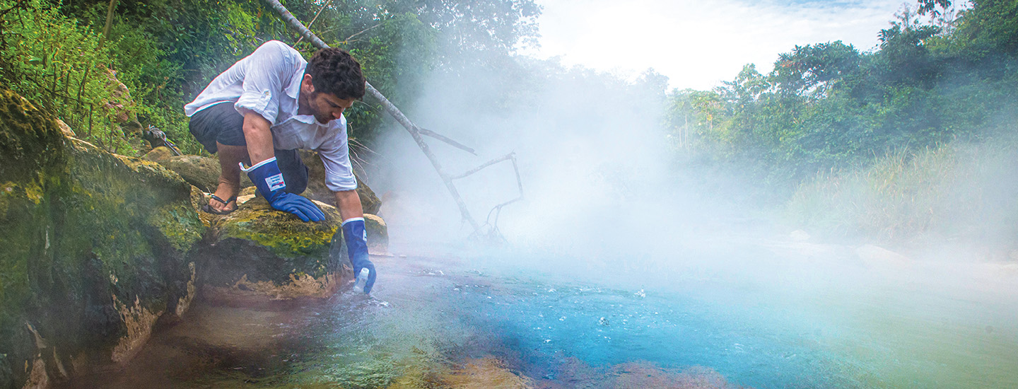 A scientist collecting samples from the Boiling River